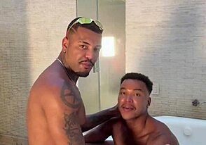 Two big black cocks in a motel bathroom scene