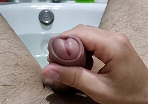 Intense gay bathroom self-pleasure close-up