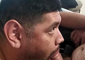 Young gay guy gives blow job while watching TV with daddy