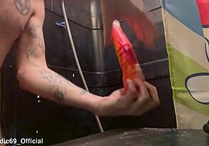 Close up of a twink’s mouth as he works on a horse cock toy in the bathroom